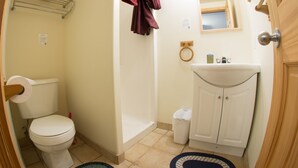 A bathroom with a toilet, sink, and shower. - Rent a Room at Cabot Shores - We are on the Cabot Trail (Englishtown)