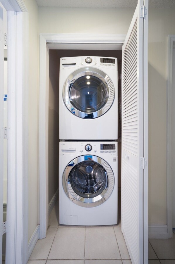 A laundry room with two stacked front-loading washing machines.