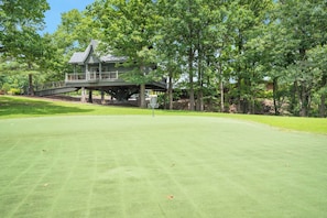 A golf course with a clubhouse and a bridge. - Real Log Cabin Near Big Cedar w Private Hot Tub & Grill on Huge Deck_Car Charger (Ridgedale)