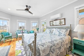 A bedroom with a bed, a ceiling fan, a window, a nightstand, and a chair. - *3rd to Beach*BIG DISCOUNTS Summer Weeks *CleanUPDTDVictorian*Across VeteranPrk (Beach Haven)