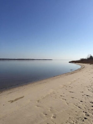 A beach with a clear sky and calm water.