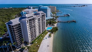 A high-rise hotel with multiple floors, a pool, and a beachside location.