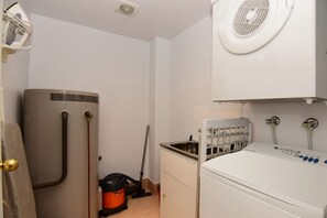 Convenient laundry facilities with washer, dryer, and sink.