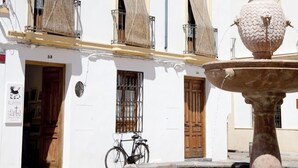 A white building with a fountain and a bicycle. - Beautiful And Central House For Up To 8 Guests (Cordoba)