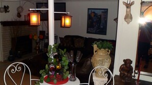A cozy indoor setting with a dining table, chairs, and a sign reading "BISTRO".