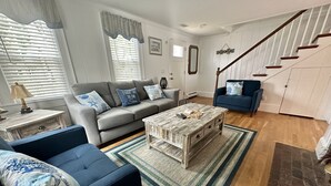 A living room with a grey sofa, blue armchair, and a coffee table. - SHORT WALK TO BEACH Central A/C (Dennis Port)