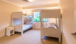 A room with bunk beds, a small bedside table, and a window with a view. - Surfside 9: In the Idyllic Yallingup Beach Scene (Yallingup)