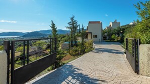 A paved pathway leading to a building with a view of the landscape. - Aegean Blue Villas - Aphrodite Villa (Kalathos)