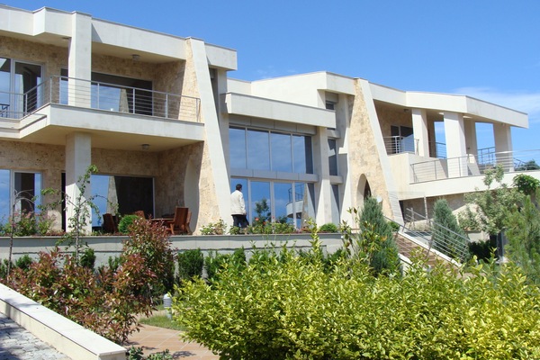 House facade with travertin and limestone , facing the sea
