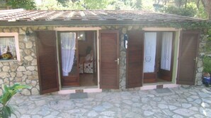 A stone building with multiple rooms, each with a wooden shutter door and a small window. - Silvia A/B - SILVIA B (Capoliveri)