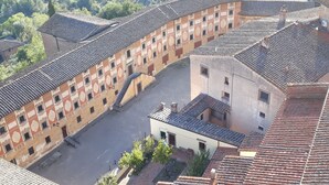 An aerial view of a courtyard with traditional tiled roofs and a central staircase. - apartment under the hill of San Miniato (san miniato)
