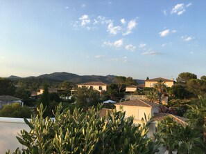 Stroll through a serene residential area surrounded by lush gardens and traditional Mediterranean architecture.