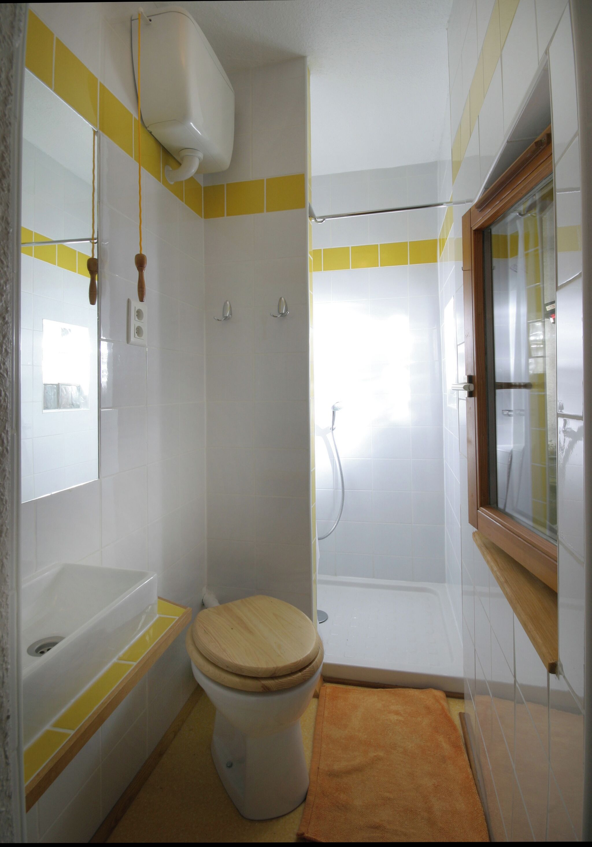 A bathroom with a toilet, bathtub, and shower.