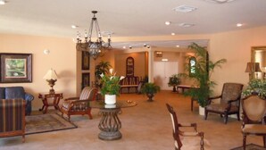 A spacious living room with a chandelier, multiple chairs, a sofa, and a coffee table. -  Condo/apt. near Disney, Universal, 3 pools, WIFI,free Parking !  (Florida)