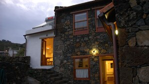 A stone building with a white upper section, featuring a staircase leading to a wooden door. - Newly restored in 2012, rural environment, fully connected, very well connected (Isora)