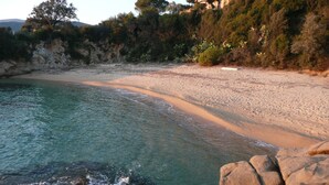 A coastal beach with clear turquoise water, sandy shore, and rocky outcrops. - House redone in VICO- WIFI- 15mns Beaches of SAGONE (Vico)