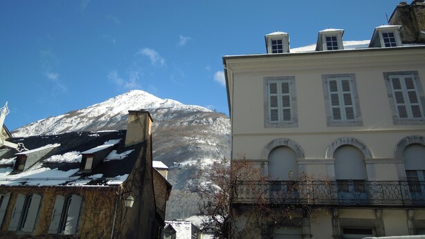A building with a snow-covered mountain in the background.