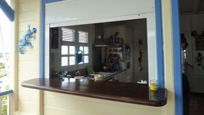 A kitchen with a counter, cabinets, and a window with blinds. - Villa with private saltwater pool and panoramic view of the sea and Diamond Rock. (RIVIERE SALEE)