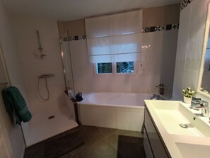 Bathtub, hair dryer, towels, soap