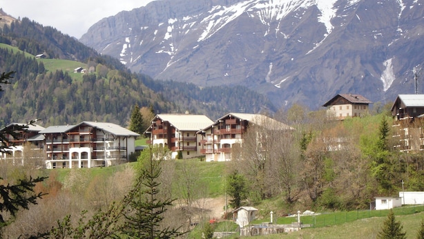 A mountainous landscape with several multi-story buildings, likely hotels, with balconies and a mix of architectural styles. - Rental in Notre Dame de Bellecombe, Espace Diamant, 500m from the ski lifts.  (notre dame de bellecombe)