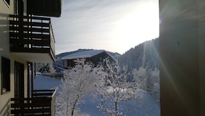 A snowy mountain landscape with a wooden cabin and a balcony overlooking the scene. - Rental in Notre Dame de Bellecombe, Espace Diamant, 500m from the ski lifts.  (notre dame de bellecombe)