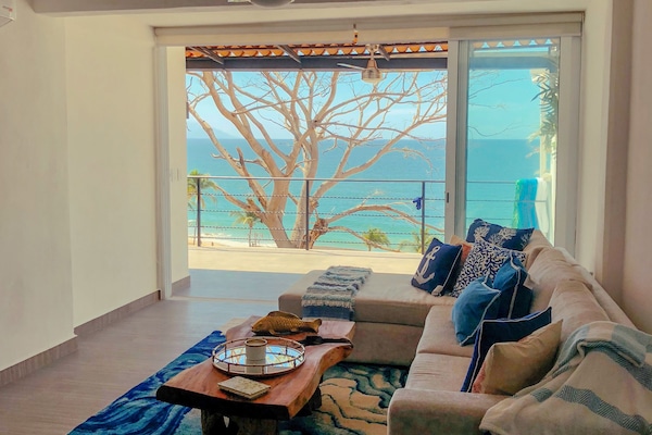 Spacious living room with comfortable seating and ocean views.