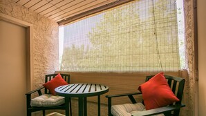 A corner seating area with two chairs and a small table, a window with blinds, and a textured wall. - GREAT condo rental conveniently located in Mesa/Phoenix   (Mesa)
