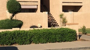 A building with a red-tiled roof, a staircase leading to a balcony, and a small tree in front. - GREAT condo rental conveniently located in Mesa/Phoenix   (Mesa)