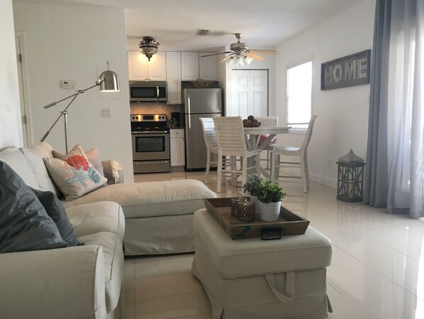Relax in a cozy living area with a sofa set and coffee table, and enjoy a view of the city from this apartment.
