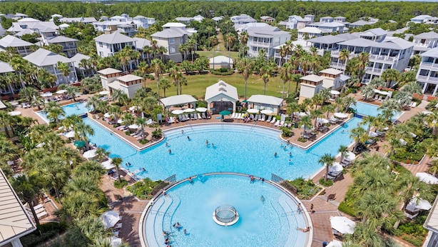A resort with multiple swimming pools, palm trees, and resort-style buildings. - Luxury Coastal Living • Breezy Partially Screened Porch & Lagoon Pool Access (Seacrest Beach)