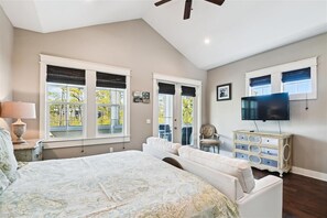 Relax in this serene bedroom with a large bed, ceiling fan, and flat-screen TV.