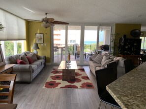 Relax in this stylish living area with a sliding glass door leading to an ocean view patio.