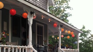 A porch with white railings, a staircase, and potted plants. - Family & dog friendly; walk to beach, cliff, town, ferries, all bedrooms w/AC (Oak Bluffs)