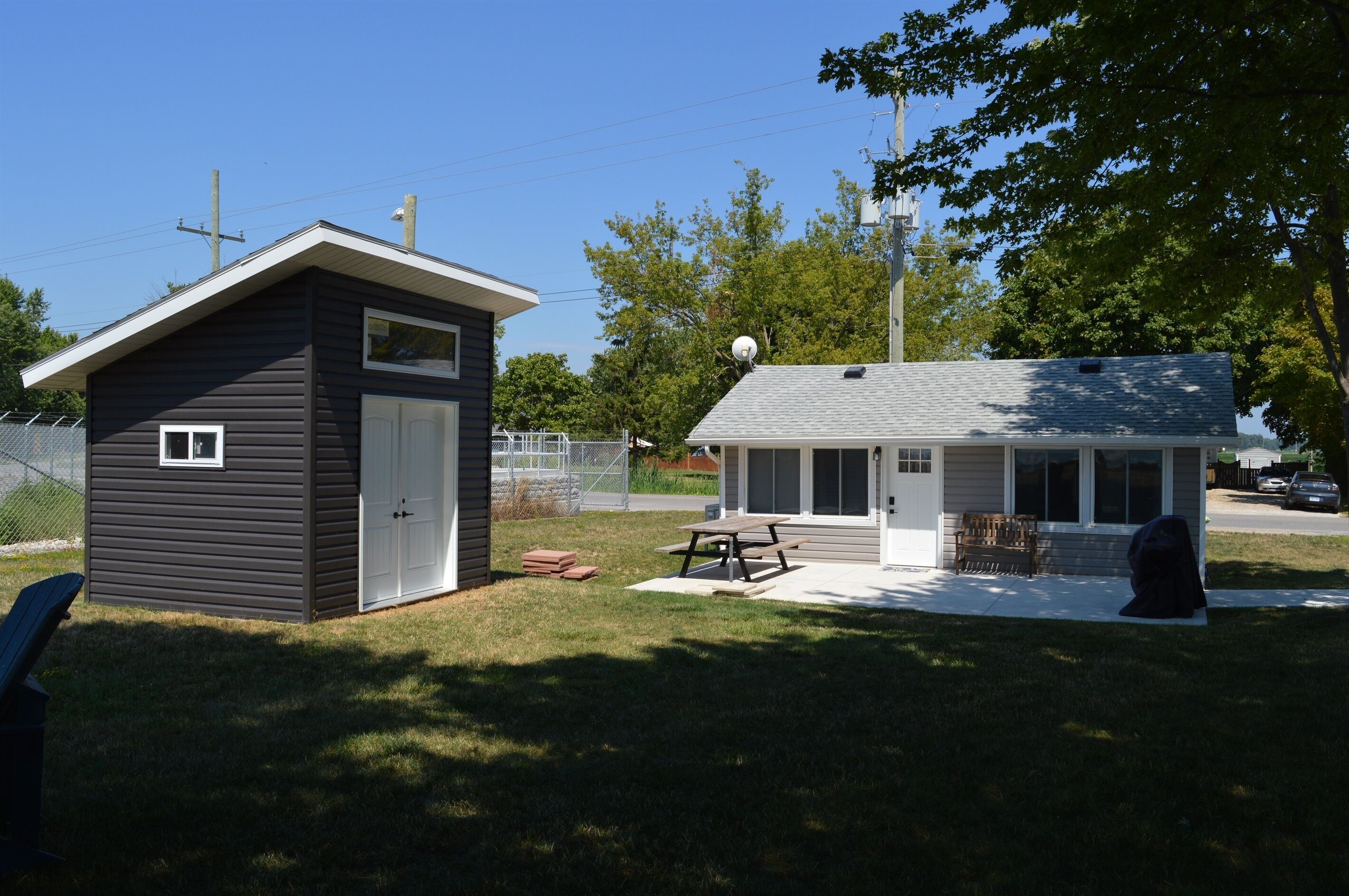 A small, single-story building with a garage and a covered patio area.