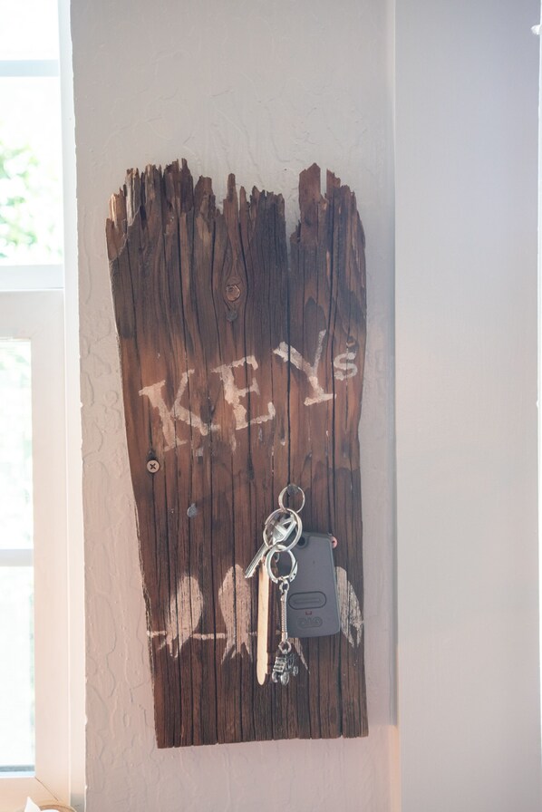 A wooden wall with a key hanging from it.
