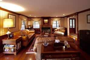 Formal living room in mahogany and leather. This is a comfortable gathering spot - 4 bedroom all suite country home features a wrap around porch on an acre of land (Portsmouth)