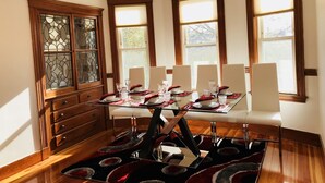 A dining room with a glass table set for six, surrounded by white chairs. - Boston Luxury Suits Cottage for up to 24 guests!!! (Boston)