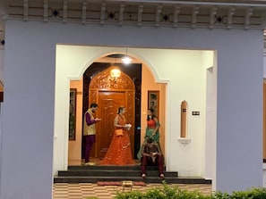 A building entrance with a decorative archway and a wooden door.