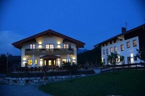 Guests can enjoy a balcony with a view from the upper floor, surrounded by a well-manicured lawn.