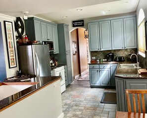 Enjoy cooking in this well-equipped kitchen with a refrigerator, stove, and coffee maker.