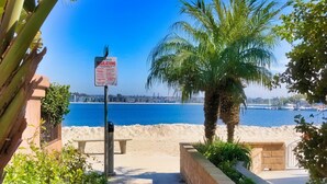 A pathway leading to a beach with a sign indicating regulations. - The BEST of the best on Mission Bay! (San Diego)