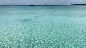A clear turquoise sea with boats and a distant shoreline. - Luxurious 4 Bed/4 Bath with Million Dollar Views (Cozumel Island)