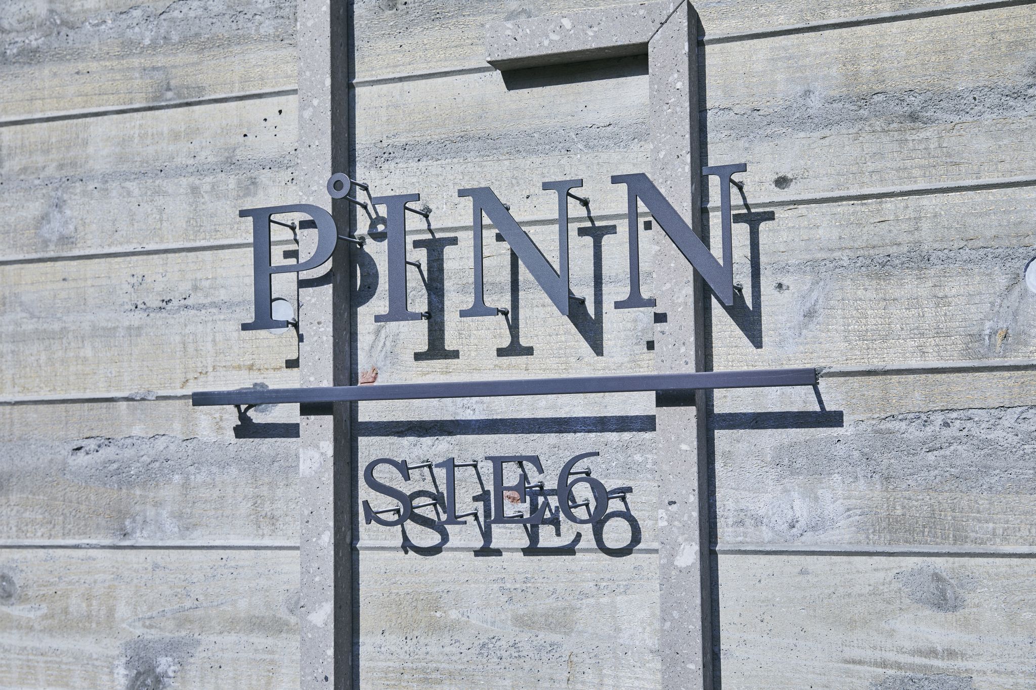 A sign with the name "PITT" and the address "STE 6".