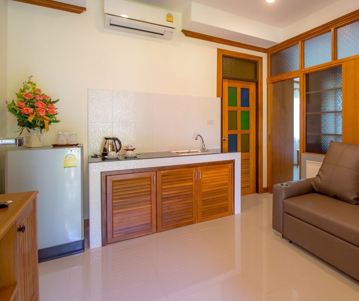 A compact kitchen with a central island, a refrigerator, and a sink.