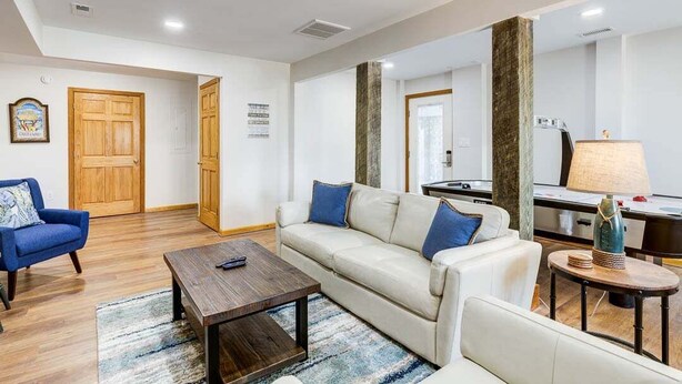 A modern living room with a sofa, armchairs, a coffee table, and a lamp. - Legacy | 980 ft from the beach | Dog Friendly, Private Pool, Hot Tub | Corolla (Corolla)