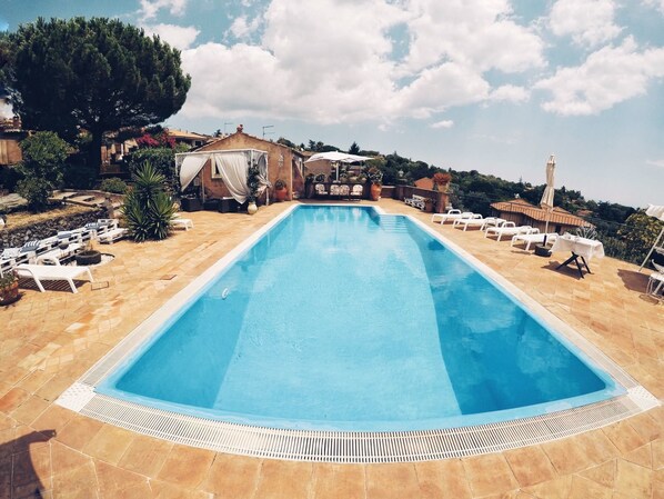 Seasonal outdoor pool, open 9:00 AM to 8:00 PM, pool umbrellas