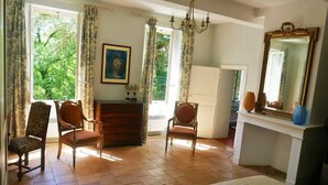 A bedroom with a bed, two chairs, a dresser, a mirror, and a window with curtains. - Very nice mansion in Fiac (Lavaur) near Toulouse (Fiac)