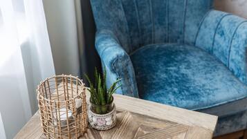 A wooden table with a woven basket and a small potted plant.
