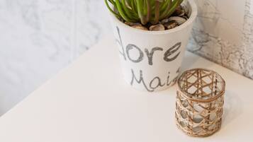 A potted succulent, a woven candle holder, and a magazine titled 'IMAGICASA' on a white surface.