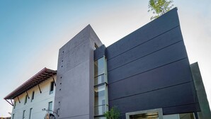 A modern building with a flat roof, large windows, and a sign that reads "HIVE". - Hive 68 - Hotel and Resorts Negombo (Negombo)